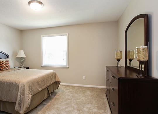 Pet-Friendly Apartments in Atlanta, GA – Estuary –a bedroom with a bed and a dresser