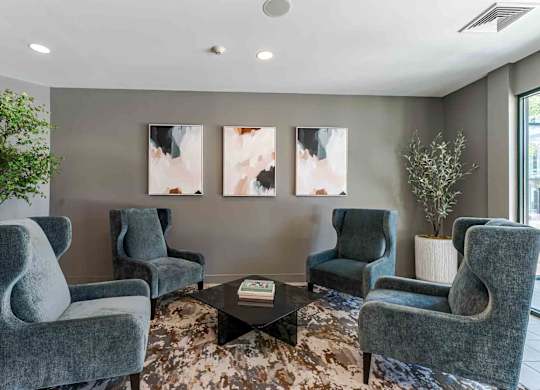A living room with grey chairs and a coffee table.