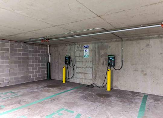 Two electric vehicle charging stations in a parking garage.