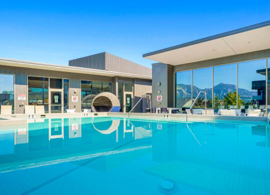 a swimming pool with a building in the background