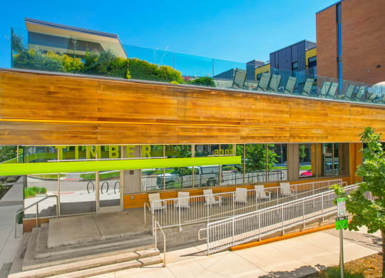 a building with a wooden facade and a green roof