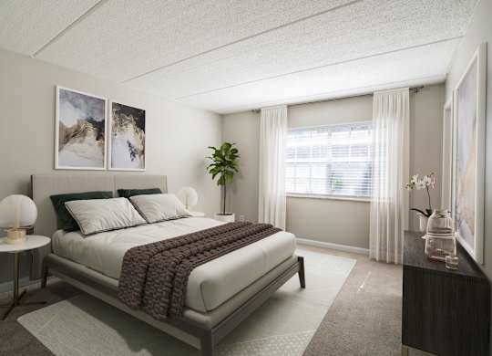Bedroom with plush carpet, large window, and good natural lighting at Townsend Apartments in Jacksonville near Atlantic Beach, Florida