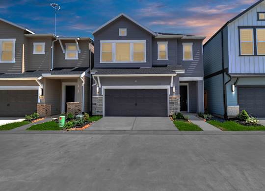 a house with a long driveway and a blue sky in the background