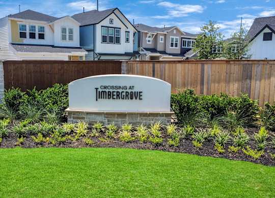 a subdivision sign in front of a row of houses
