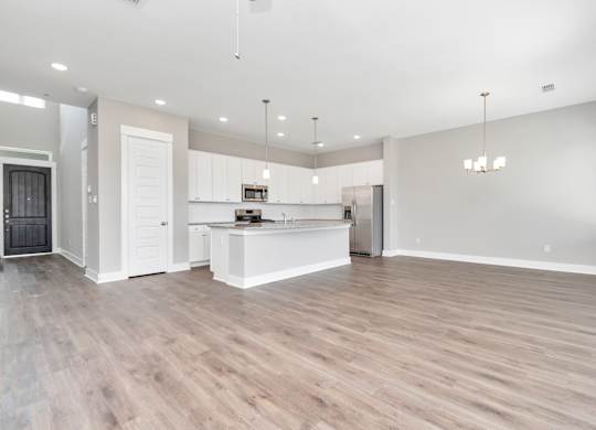 the living room and kitchen in a 555 waverly unit