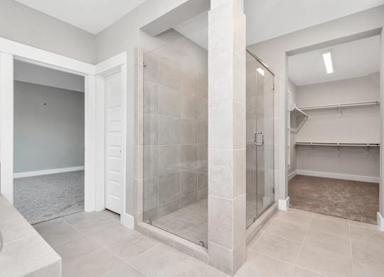 a large walk in shower with tiled walls and floors