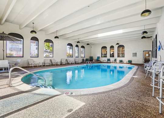 Trailgrove Apartments indoor pool amenity near 2470 South Quebec Street with spacious seating and bright skylights