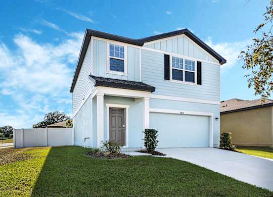 A two-story house with a white garage door.
