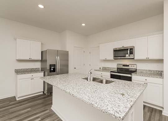A kitchen with granite countertops and stainless steel appliances.