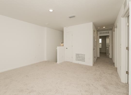 A room with white walls and carpeted floor.