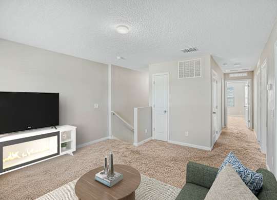 A living room with a television and a couch.