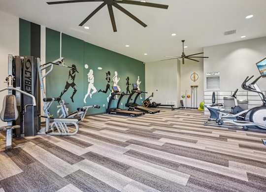 Willowstone Apartments fitness center in Denver CO offering multiple cardio machines and a bright, open exercise area