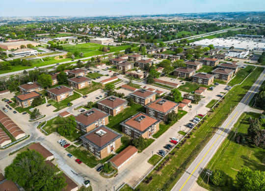 arial view of a neighborhood with brick houses and green grass