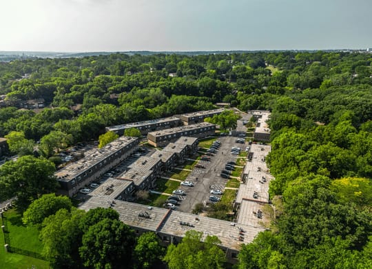an aerial view of an abandoned building surrounded by trees