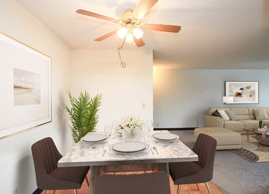 a dining room with a table and chairs and a ceiling fan