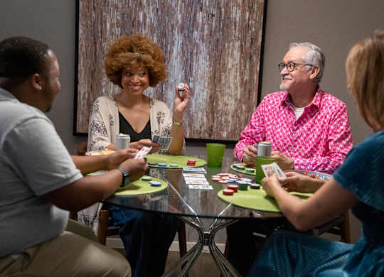 A group of people playing a card game.