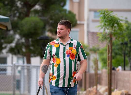 A man walking his dog on a leash. at Habitat @ DTLV, Las Vegas, NV