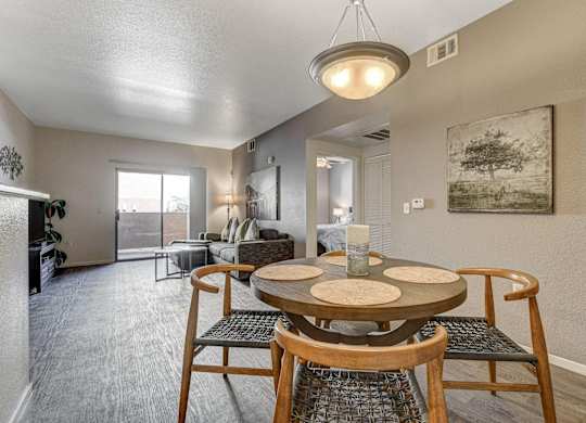 A dining room with a round table and chairs.