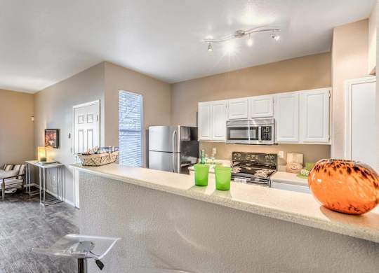A kitchen with a white counter and a bowl on it.