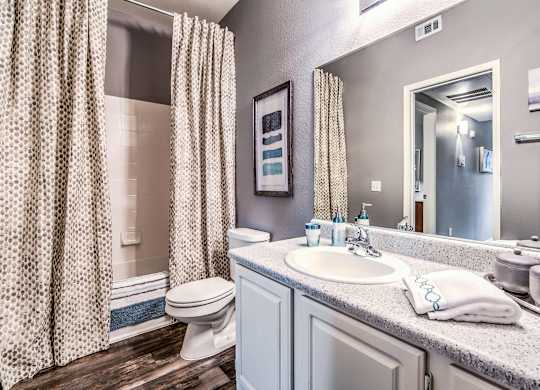 A bathroom with a white sink and a white toilet.
