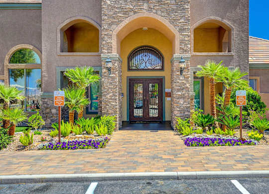 A building with a brown door and a sign in front of it.