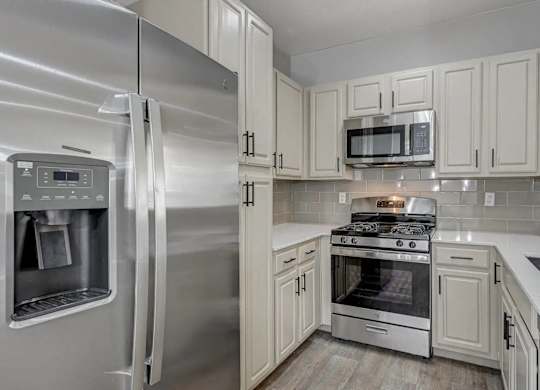 A modern kitchen with a stainless steel refrigerator and oven. at Habitat @ DTLV, Las Vegas, NV, 89106