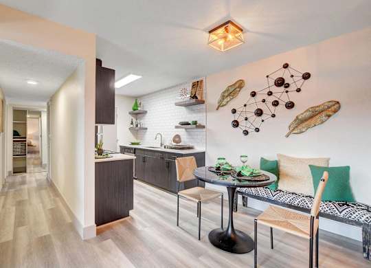 A modern kitchen with a dining table and chairs.