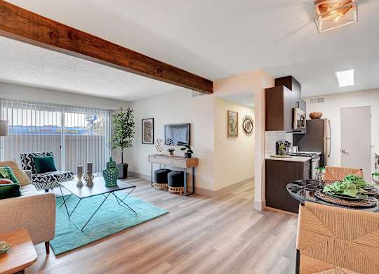 A modern open plan living and kitchen area with a dining table and chairs.