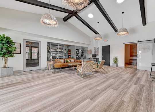 A living room with a wooden floor and a large window.