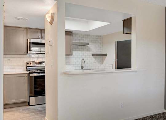 A kitchen with a stove top oven and a microwave.