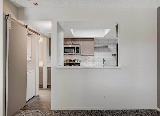 A kitchen with white cabinets and a white countertop.