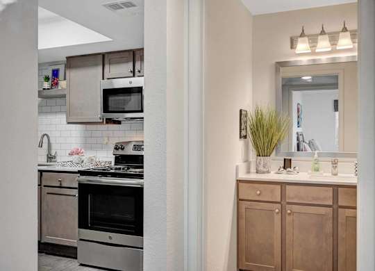 A kitchen with a stove top oven and a microwave above it.