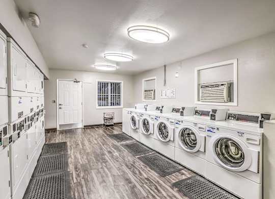 A row of washing machines in a laundromat.