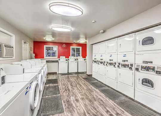 A row of washing machines in a laundromat.