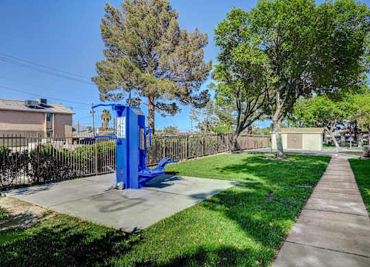 A blue playground structure in a sunny park.