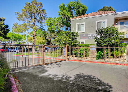 A gated entrance to a building with a sign that reads "Welcome Center".