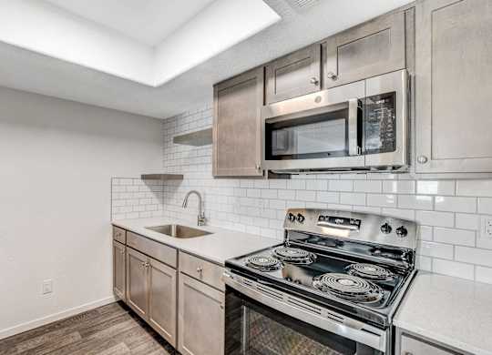 A modern kitchen with a stainless steel oven and microwave above the stove. at The 95 Apartments, Las Vegas, 89129