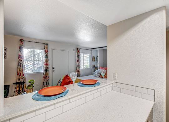 A kitchen with a white counter and a window with curtains. at The 95 Apartments, Las Vegas, Nevada
