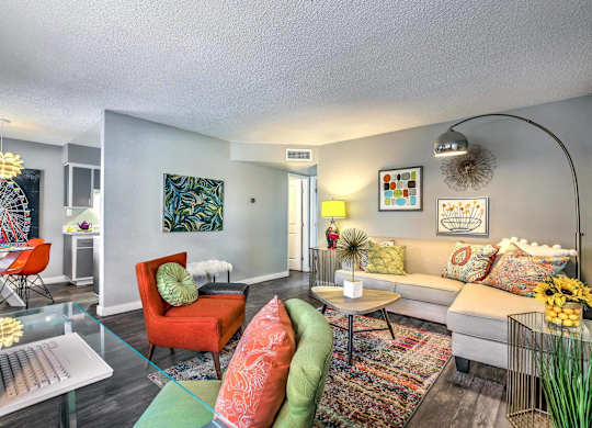 A living room with a sofa, chairs, and a table.