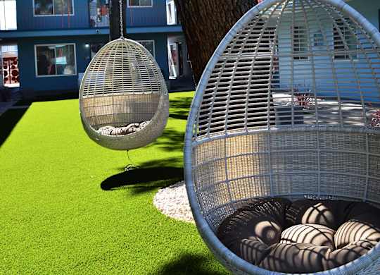 A large birdcage with a smaller one next to it.