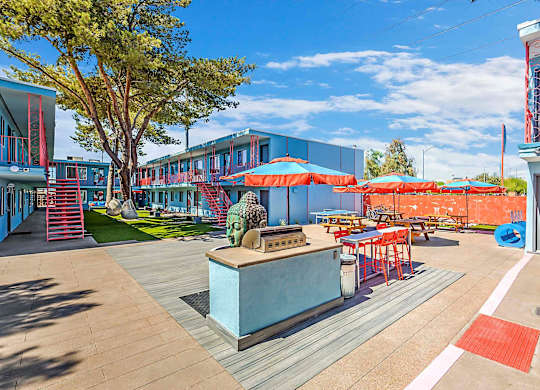 A sunny day at a colorful outdoor seating area with tables and chairs.