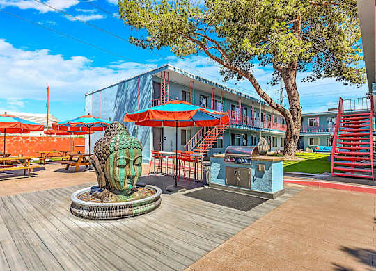 A sculpture of a face sits in the middle of a wooden deck.
