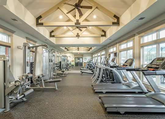 A spacious gym with treadmills, elliptical machines, and other exercise equipment.