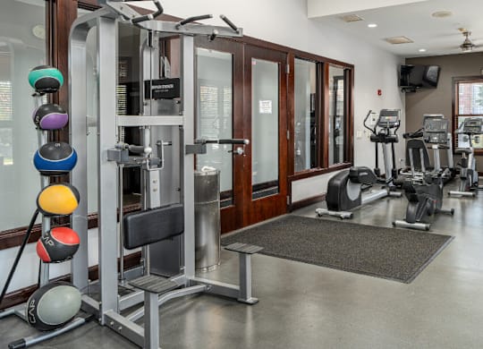 a gym with weights and cardio equipment in a building at Bristol Station, Naperville