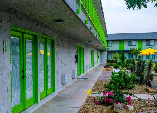 Fusion Las Vegas apartment complex interior courtyard with blooming desert landscaping and lime green railing on second story.