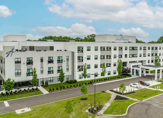 A large white building with the Altura Sign