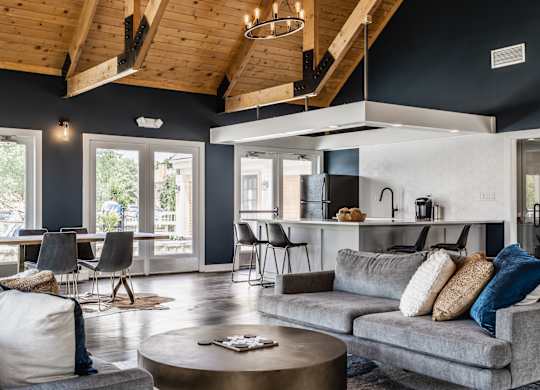 Fairway Lakes clubhouse featuring a grey couch, tables and chairs, and modern decor.