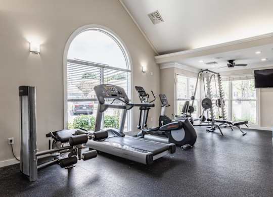 Fairway Lakes fitness center featuring workout equipment and windows.