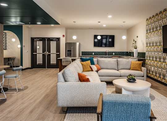 Altura Apartments spacious yoga studio equipped with a television screen for instruction or entertainment.
