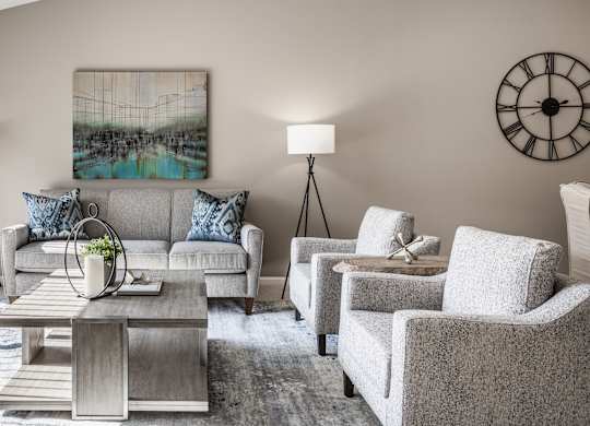 Bedford Place Apartments in Blacklick, Ohio features an updated living room with abundant natural sunlight, carpeting, and a spacious layout.